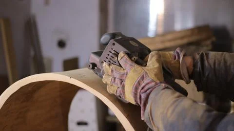 Sanding the surface of wood material with a machine Stock Photos