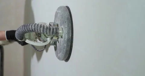 Sanding Walls for painting using Wall Sander close up. Preparing Walls for Stock Footage 150723997
