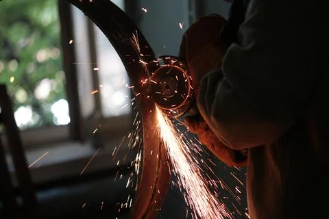 Sanding the welded joint with a grinder 스톡 사진
