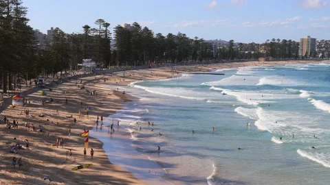 Sands and waves of Manly beach in Sydney – zoom out over people in 4k. Stock Footage 143139516
