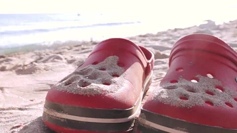 Sands flying over slippers on the beach. Stock Footage 138666304