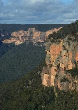 Sandstone cliffs rise above the forest in the Blue Mountains, Australia. Stock Photos