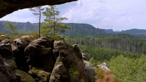Sandstone cliffs rising above pine forest, Saxon Switzerland, Kuhstahl, Germany. Stock Footage 341462275