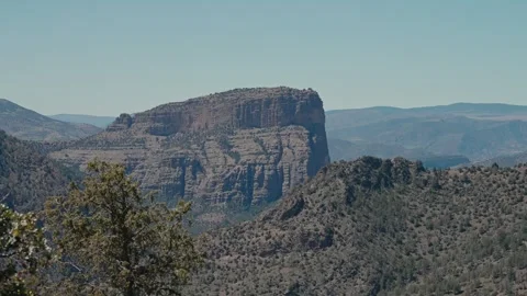 Sandstone Mesa Cliff Above Juniper Canyon and Distant Mountain Ridges Stock Footage 340595834