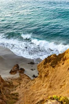 Sandstone path overlooking cliff side, pacfic ocean expanse, and waves on the Stock Photos