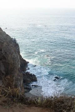 Sandstone path overlooking cliff side, pacfic ocean expanse, and waves on the Stock Photos
