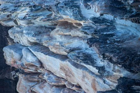 Sandstone rock face cliff surface layers weathered by seaside, ideal background Stock Photos