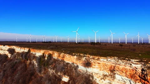 Sandstone sea cliffs with wind turbines on plateau edge, Bulgaria Video stock 336726451