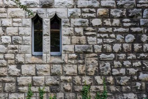 Sandstone wall with two windows, Small Windows , Two windows in a sandstone wall Stock Photos