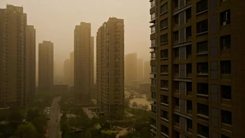 Sandstorms in Chinese cities - walking between residential buildings Stock Footage 257175655