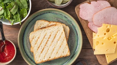 Sandwich with cheese, ham, tomato sauce, с bread, the process of making Stock Footage 129704228