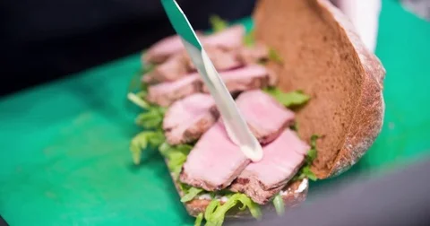 Sandwich cooking 4k video: chef puts sauce on half of sandwich, ham bread herbs Stock Footage 71154635