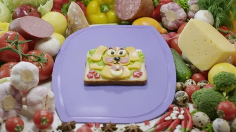 Sandwich in dog shape on chopping board among ingredients Stock Footage 231222309