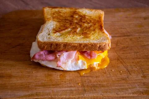 Sandwich with Egg, Bacon, Cheese and Spicy Sauce Stock Photos