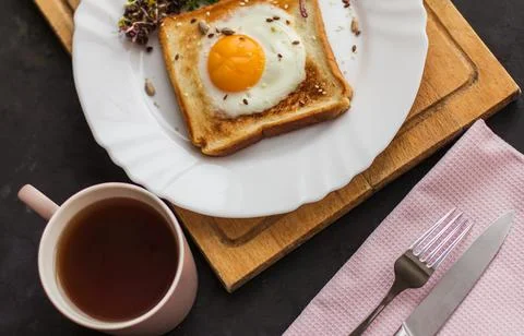 A sandwich with egg in the hole of the bread, microgreens, healthy food Break Stock Photos