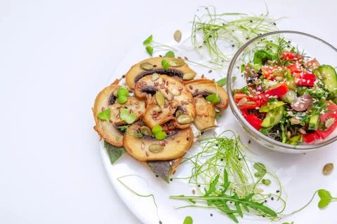 Sandwich with fried mushrooms and tomato and cucumber salad Stock Photos