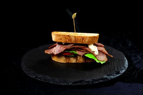 Sandwich with hamon on black background Stock Photos