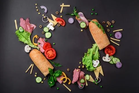 Sandwich ingredients pattern. Creative layout of ingredients on black background Stock Photos