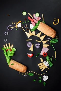 Sandwich ingredients pattern. Creative layout of ingredients on black background Stock Photos