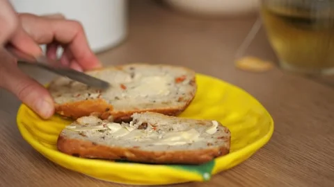 Sandwich Making. Part 2. Hands spreading butter  onto a bread Stock Footage 326238738