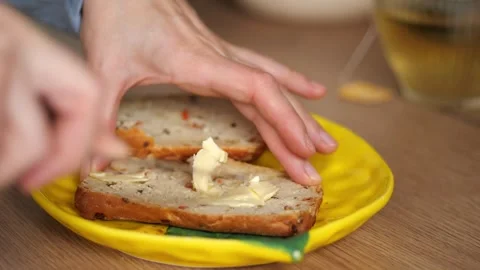 Sandwich Making. Part 2. spreading butter onto a slice of fresh bread Stock Footage 326238687