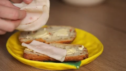 Sandwich Making. Part 3.  placing a slice of pale sausage onto the bread Stock Footage 326238777