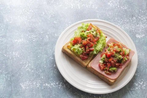 Sandwich open has ham cheese and tomato cucumber on wood table. Stock Photos