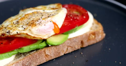 Sandwich with poached egg cherry tomato and avocado Stock Footage 170667961