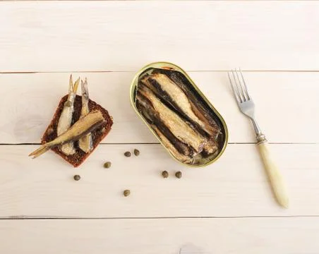 Sandwich with rye bread, capers and canned sprats Stock Photos