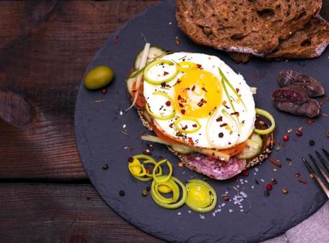 Sandwich with a slice of rye bread and fried egg 스톡 사진