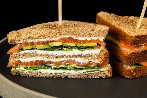 Sandwich, vegetable, toasted bread on white plate. salmon club Stock Photos
