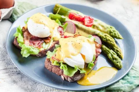 Sandwiches with bacon, poached egg and asparagus Stock Photos