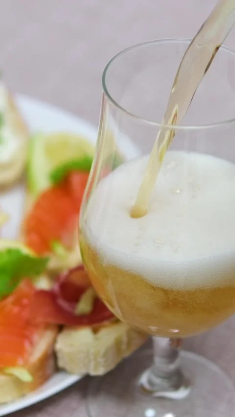 Sandwiches beer pouring Preparing Beer and Snacks: Pouring Drinks and Arranging Stock Footage 303489134