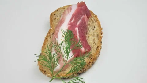 Sandwiches from rye bread with bacon close up rotation 4K. Stock Footage 218629394