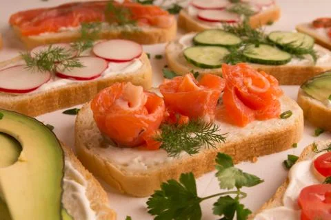 Sandwiches with trout pieces, avocado, radishes. Perfect for breakfast. On a Stock Photos