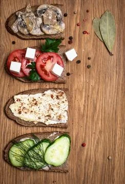 Sandwiches on wooden serving board, top view, copy space. Stock Photos