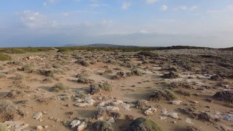 The sandy and stony terrain is captured on camera at the sunset. 스톡 동영상 242481555