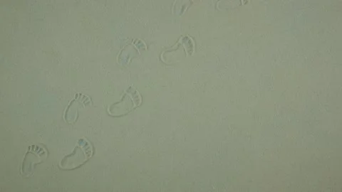 Sandy background with footprints. Large space for text. Stop motion animation Video stock 194572049