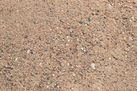 Sandy background: rough construction sand surface, small stones Stock Photos