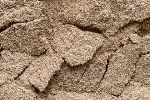 Sandy background: rough construction sand surface, small stones Stock Photos