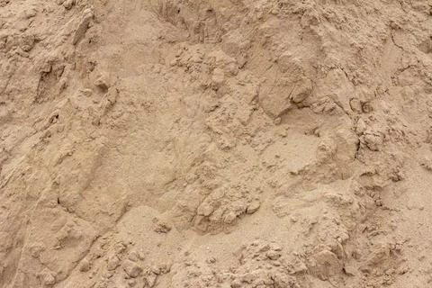 Sandy background, texture of dry sand with lumps. Stock Photos