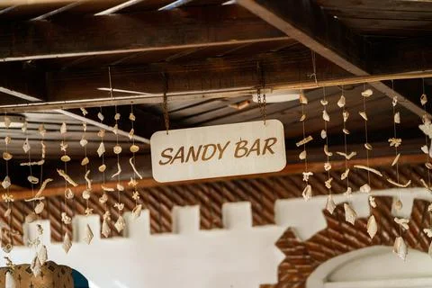 Sandy bar sign hanging with seashells decoration Stock Photos