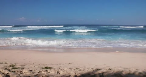 Sandy beach and blue ocean with waves in tropics Stock Footage 252734641