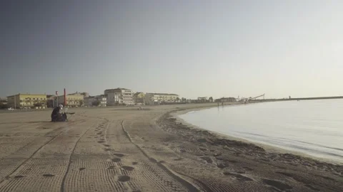 Sandy beach and calm sea bay with a person relaxing on the shore Vidéo 342445938