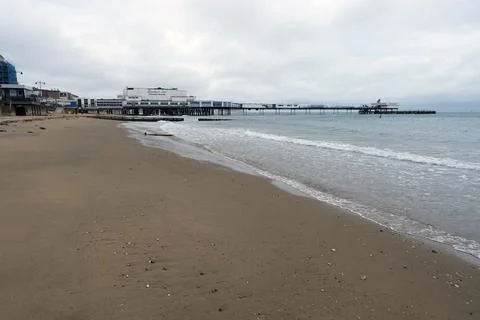 Sandy Beach and Ocean Waves with Sandown Pier and Seaside Town, iow Stock Photos