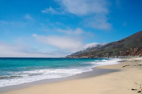 Sandy beach and small cliffs Stock Photos