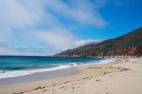 Sandy beach and small cliffs Stock Photos