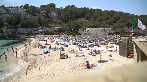 Sandy beach and tourists Stock Footage 128348968