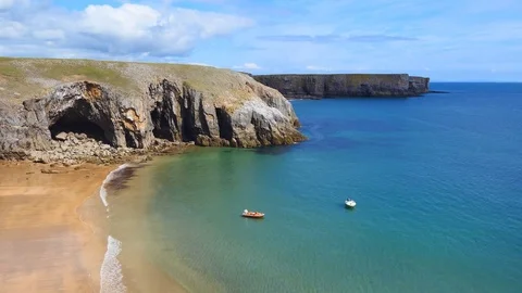 Sandy beach and turquoise ocean water. Rocky coast of Wales. Great Britain. Stock Footage 84722168