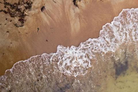 Sandy beach and waves. View from above. Stock Photos